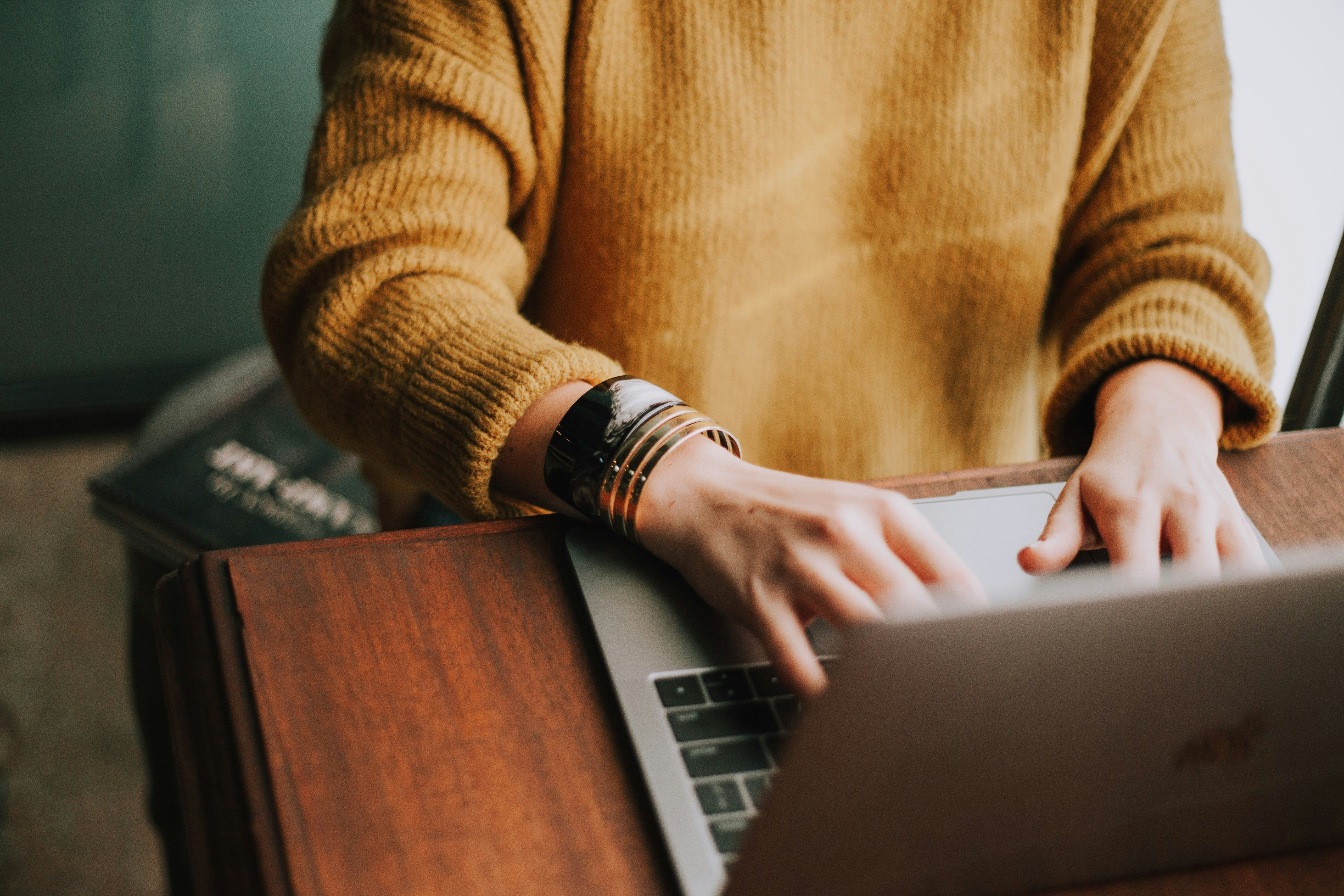 Person working on laptop managing accounts receivable